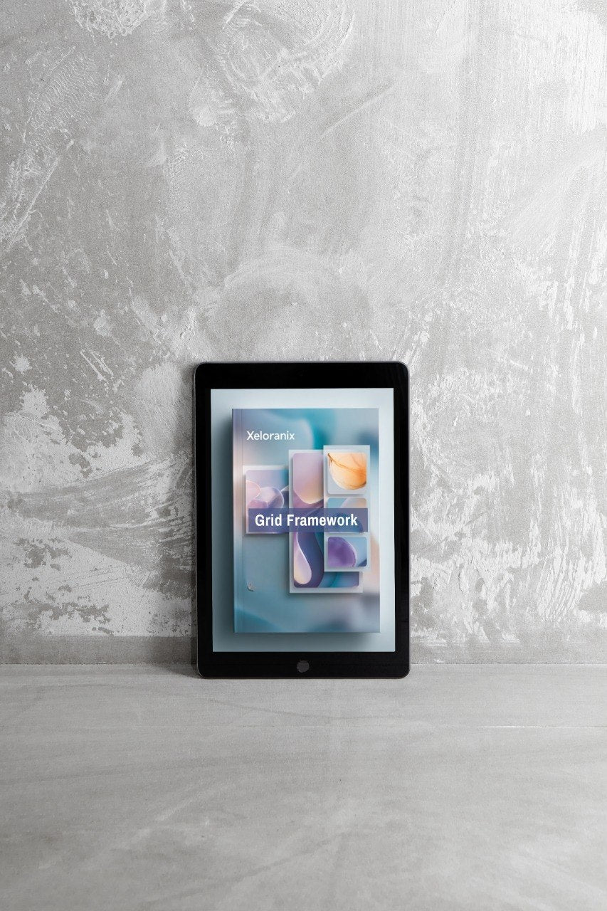 Digital tablet displaying a Xeranox cloud framework app on a textured gray wall background